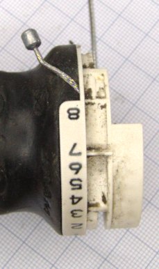 The cable threaded through the moving part. The end of the cable is sticking out.