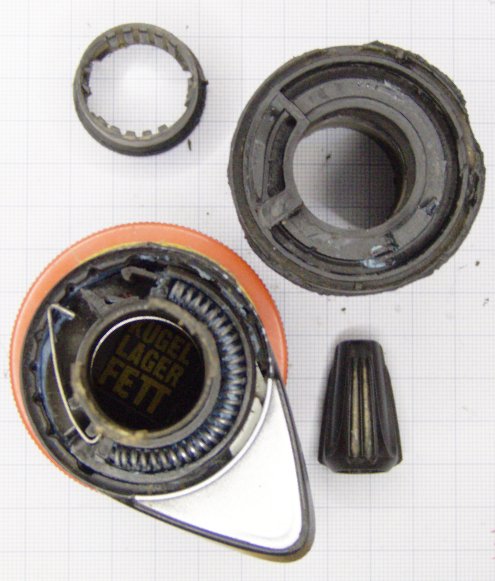Two halves of the X.O 9-gear and a spring as seen from the axis of rotation
